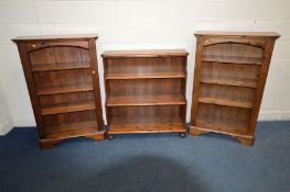 A PAIR OF STAINED PINE BOOKCASES, width 77cm x depth 31cm x height 120cm, with three adjustable