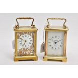TWO BRASS CARRIAGE CLOCKS, the first with a foliate panel over the roman numeral dial, 110mm in