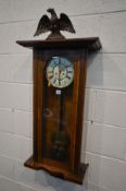 A LATE VICTORIAN WALNUT VIENNA EIGHT DAY WALL CLOCK, with papier Mache eagle pediment, enamel dial