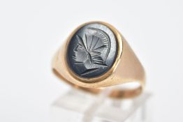 A 9CT GOLD GENTS HEMATITE INTAGLIO SIGNET RING, of an oval form depicting a Roman soldier, plain