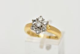 AN 18CT GOLD DIAMOND CLUSTER RING, flower shaped slightly raised cluster, set with seven claw set,