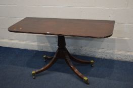 A REGENCY MAHOGANY D-END PEDESTAL TABLE, on four swept reeded legs terminated on brass caps and