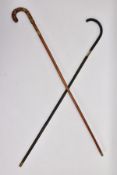 TWO EARLY 20TH CENTURY SWORD STICKS, one plain ebonised with brass fittings, estimated sword