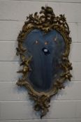 A 18TH/19TH CENTURY GILT ON PLASTER ROCOCO WALL MIRROR, depicting a pair of cherubs between open