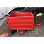 A RED RIDE ON LAWNMOWER GRASS TIPPING TRAILER