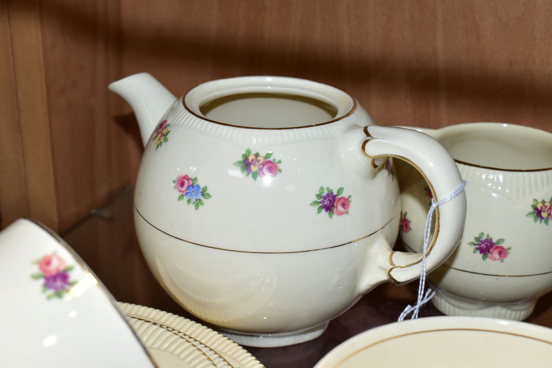 A CLARICE CLIFF NEWPORT POTTERY PART TEA SET, transfer printed with floral sprays, Reg no 840076, - Image 6 of 8