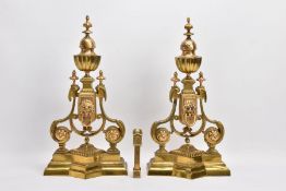 A PAIR OF BRASS FENDER ENDS with lions head motifs, height 45cm, paired with a Victorian brass