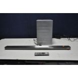 A LG NB4540 BLUETOOTH SOUNDBAR with Brushed stainless steel finish, remote and a LG S44A1-D wireless
