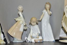 THREE NAO BY LLADRO FIGURINES, comprising a small girl holding a doll, approximate height 16cm, a