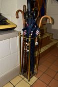 A MODERN BRASS STICK STAND, containing a quantity of wooden walking sticks and umbrellas, height