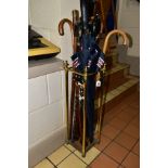 A MODERN BRASS STICK STAND, containing a quantity of wooden walking sticks and umbrellas, height