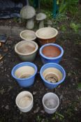 EIGHT VARIOUS GLAZED PLANT POTS, along with three graduated composite garden mushrooms, a wrought