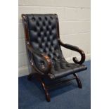 A BLACK FAUX LEATHER BUTTONED AND MAHOGANY SLIPPER ARMCHAIR