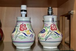 TWO POOLE POTTERY TABLE LAMPS OF BALUSTER FORM, both hand painted with flowers on a white ground,