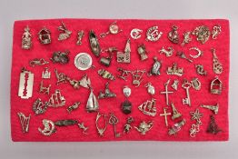 A TRAY OF ASSORTED SILVER AND WHITE METAL CHARMS, sixty three charms in total such as a silver