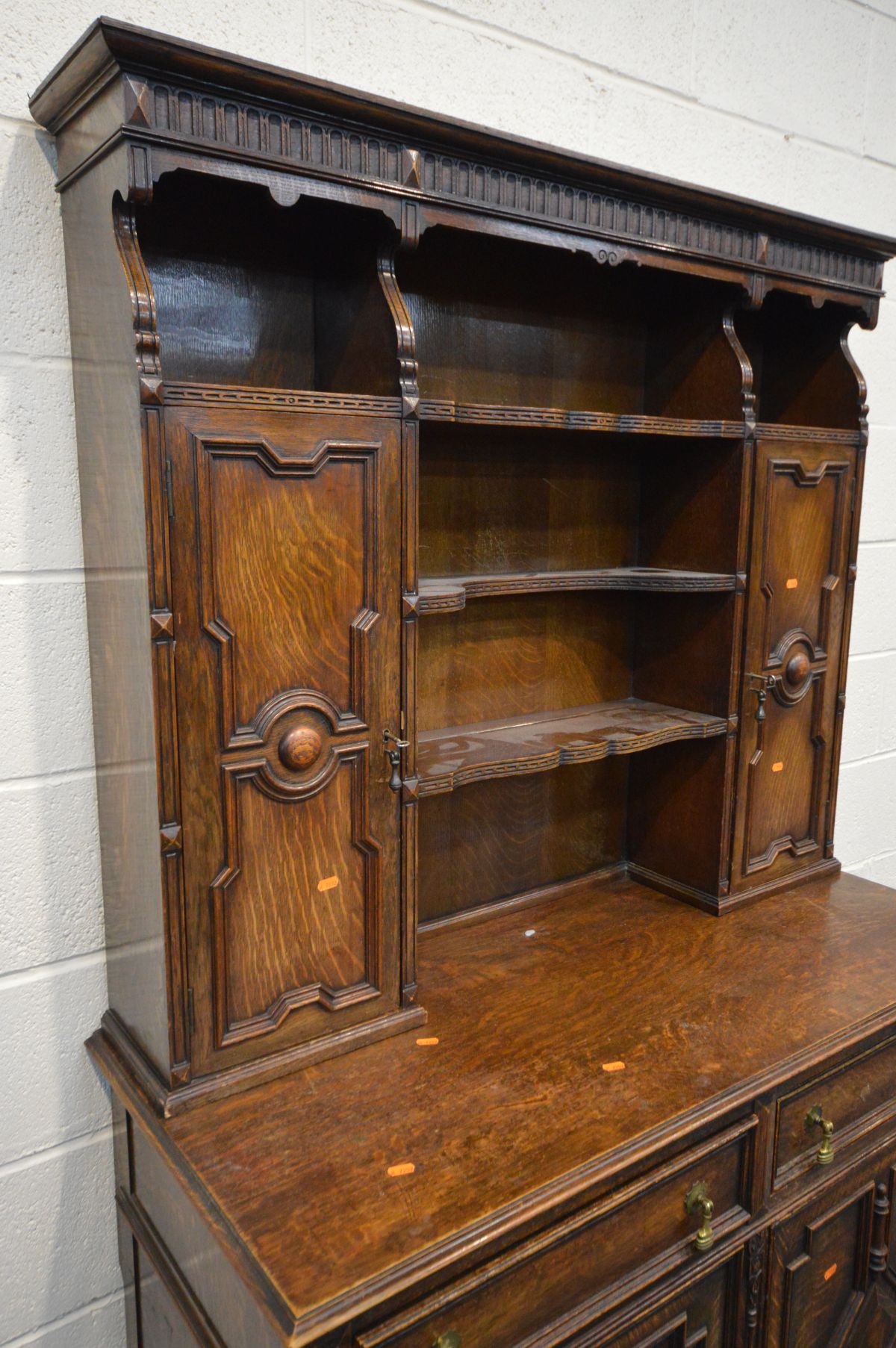 AN EARLY 20TH CENTURY OAK GEOMETRIC DRESSER, the top with two cupboard doors flanking an - Image 2 of 4