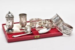 FOUR SILVER NAPKIN RINGS AND A SILVER TEASPOON, to include a circular beaded rim, floral and