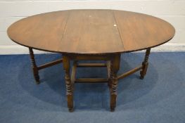 A MID TO LATE 20TH CENTURY OAK OVAL GATE LEG TABLE, open length 179cm x depth 121cm x closed