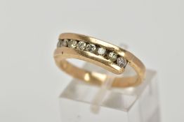 A 9CT GOLD DIAMOND HALF HOOP RING, designed with a row of round brilliant cut diamonds, cross over