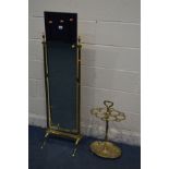 A BRASS CHEVAL MIRROR supported by twin Corinthian columns supports with finials and splayed legs