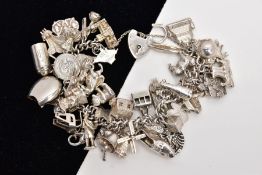 A WHITE METAL CHARM BRACELET, suspending forty-six charms in forms such as tankard, Toby jug,