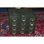 AN INDUSTRIAL INDEX CABINET, made up of twelve drawers adjoined from three separate cabinets,
