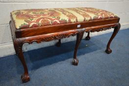 A VICTORIAN STYLE MAHOGANY DUET STOOL, with a floral drop in seat pads, on six ball and claw feet,