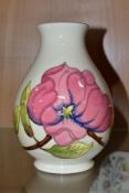 A MOORCROFT POTTERY BALUSTER VASE WITH PINK MAGNOLIA ON A CREAM GROUND, painted and impressed marks,
