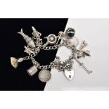 A SILVER CHARM BRACELET, suspending sixteen charms in forms such as a claw holding a bloodstone