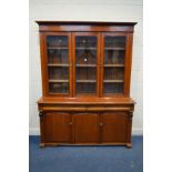 A VICTORIAN WALNUT BOOKCASE, triple glazed doors enclosing three fixed shelves, above two long