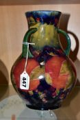 A MOORCROFT POTTERY THREE HANDLED VASE, Pomegranate pattern, signed and dated 1918, height 22cm (
