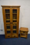 A SOLID GOLDEN OAK DOUBLE DOOR BOOKCASE, enclosing four fixed shelves above two drawers, width