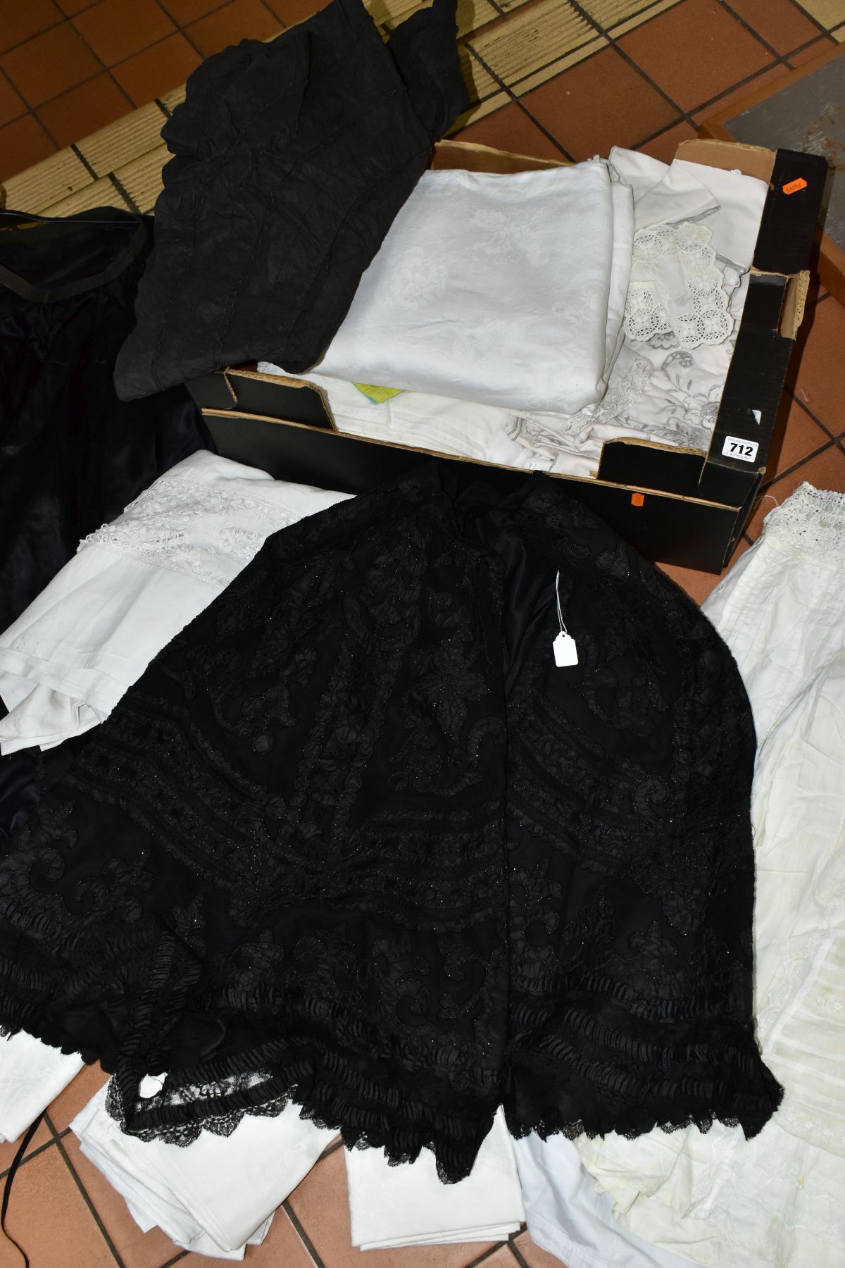 A BOX OF COSTUME AND TEXTILES including a beaded Victorian mourning cape with further mourning wear,