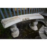 A COMPOSITE JAPANESE CURVED GARDEN BENCH on a twin supports, length 112cm