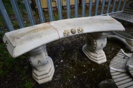 A COMPOSITE JAPANESE CURVED GARDEN BENCH on a twin supports, length 112cm