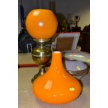 A BRASS OIL LAMP, in working condition with chimney and damaged orange shade, together with a