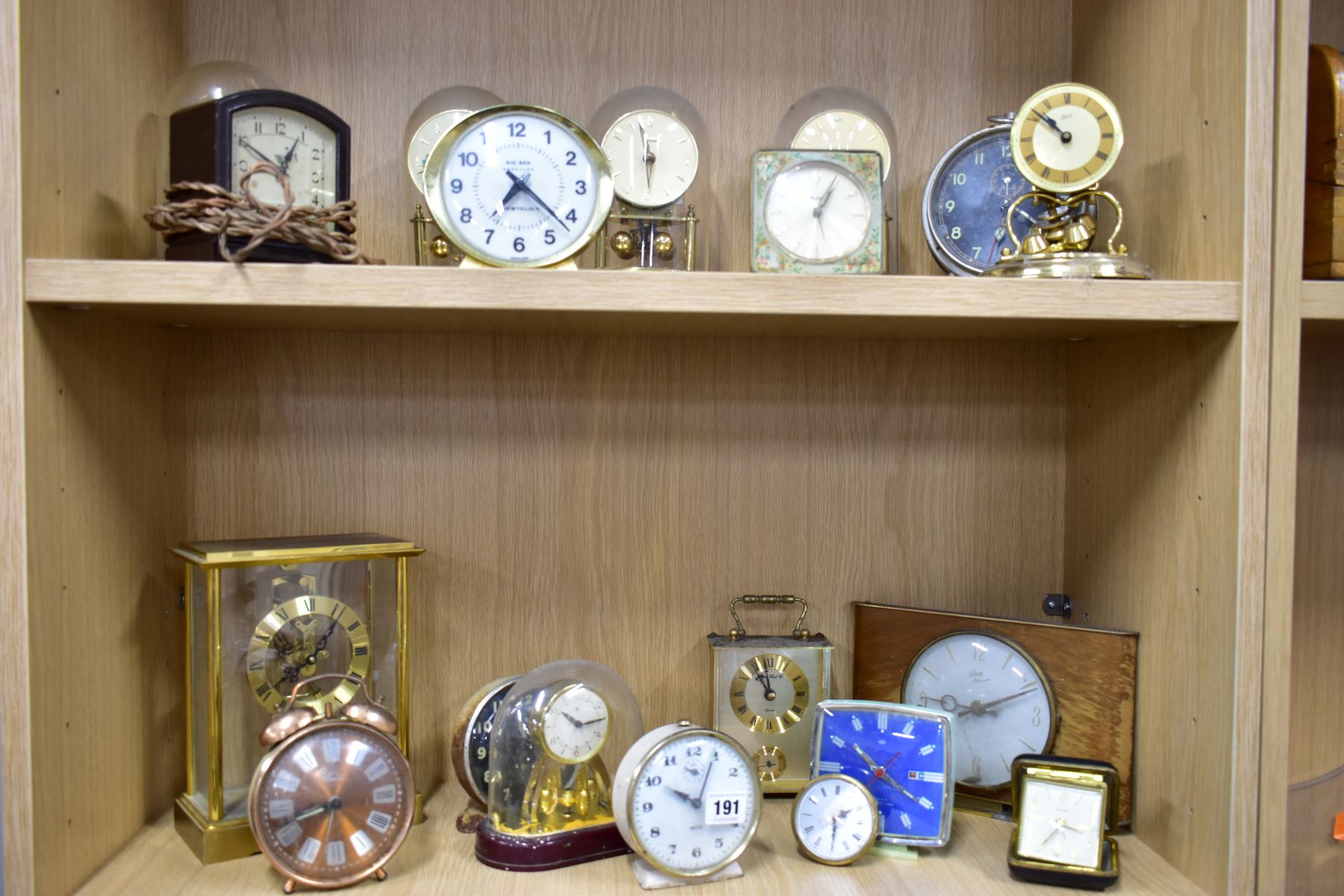 NINETEEN MANTLE AND BEDSIDE CLOCKS, to include four plastic domed rotating pendulum clocks, such