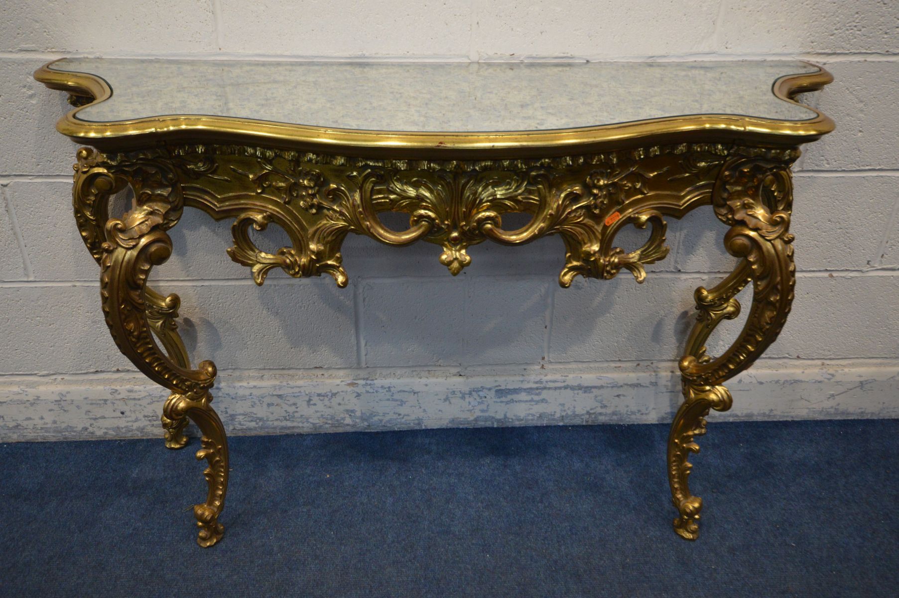 A LATE 20TH CENTURY GILTWOOD FRENCH STYLE HALL TABLE, with a decorated mirror top on four legs,