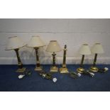 A COLLECTION OF BRASS COLUMN LAMPS, to include a pair of Corinthian column lamps on a stepped