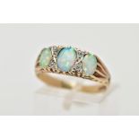 A 9CT GOLD RING, designed with three synthetic oval cabochon opals, interspaced with circular cut