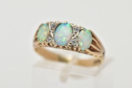 A 9CT GOLD RING, designed with three synthetic oval cabochon opals, interspaced with circular cut