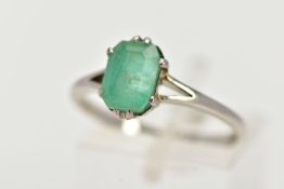 A WHITE METAL EMERALD RING, centering on a claw set emerald, cut emerald approximate dimensions 8.