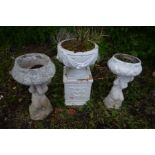 A PAIR OF GARDEN URN, on a putto supports, one later painted white, height 68cm along with a