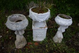 A PAIR OF GARDEN URN, on a putto supports, one later painted white, height 68cm along with a