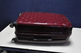 A LULU GUINESS HARD SHELL SUITCASE in Burgundy and 4 wheels, width 50cm x depth 30cm x height 79cm