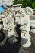 A PAIR OF COMPOSITE PUTTO GARDEN FIGURES, holding a bunch of grapes, height 88cm (chip to bottom rim