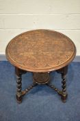 A 1920'S CIRCULAR CARVED OAK CENTRE TABLE, on angled barley twist legs united by bobbin turned