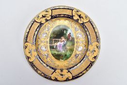 A VIENNA PORCELAIN CABINET PLATE, handpainted with a courting couple within an enamelled and