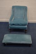 A VICTORIAN ARM CHAIR, with swept armrests, reupholstered pale blue, on scrolled front legs and