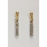 A PAIR OF GOLD PLATED DIAMOND DROP EARRINGS, each earring suspending a bar drop set with single